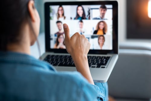 Business woman making video call and showing thumb up to laptop on the online meeting