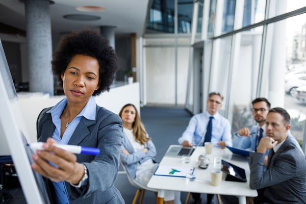 Person leading a business meeting with colleagues