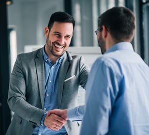 cheerful manager passionately handshaking with new employee_cropped