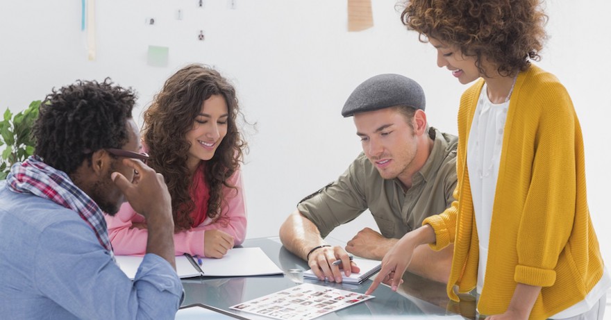 coworkers-going-over-schedule-at-desk