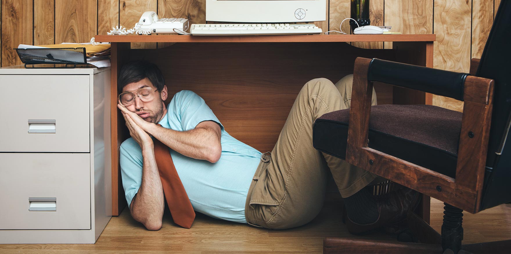 exhausted-employee-under-desk